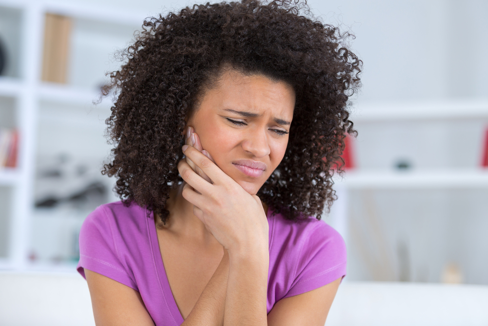 woman dealing with mouth pain